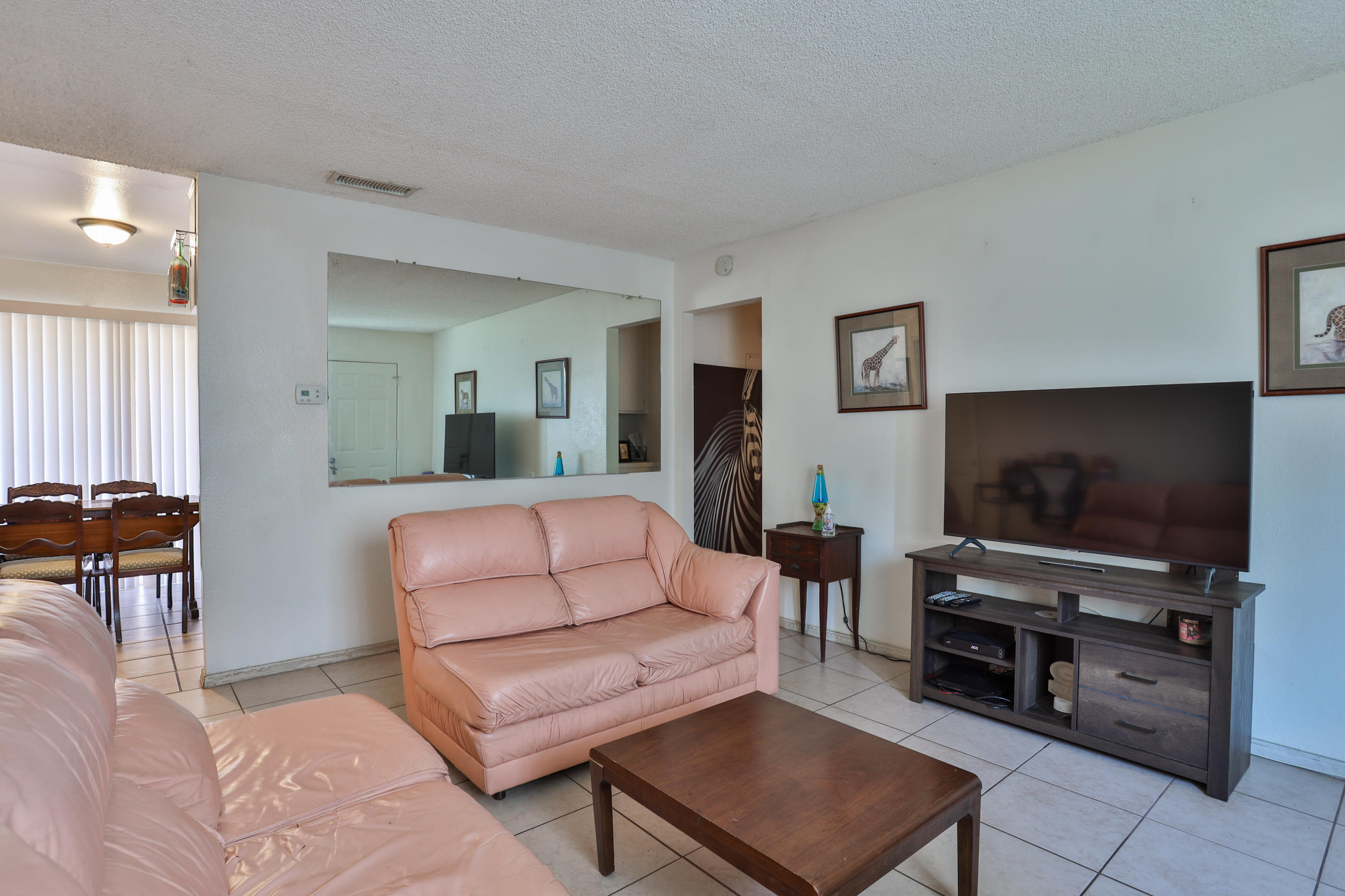 464 Riverside Avenue Rialto, CA 92376 - Photo 7 of 33 a living room with furniture and a flat screen tv