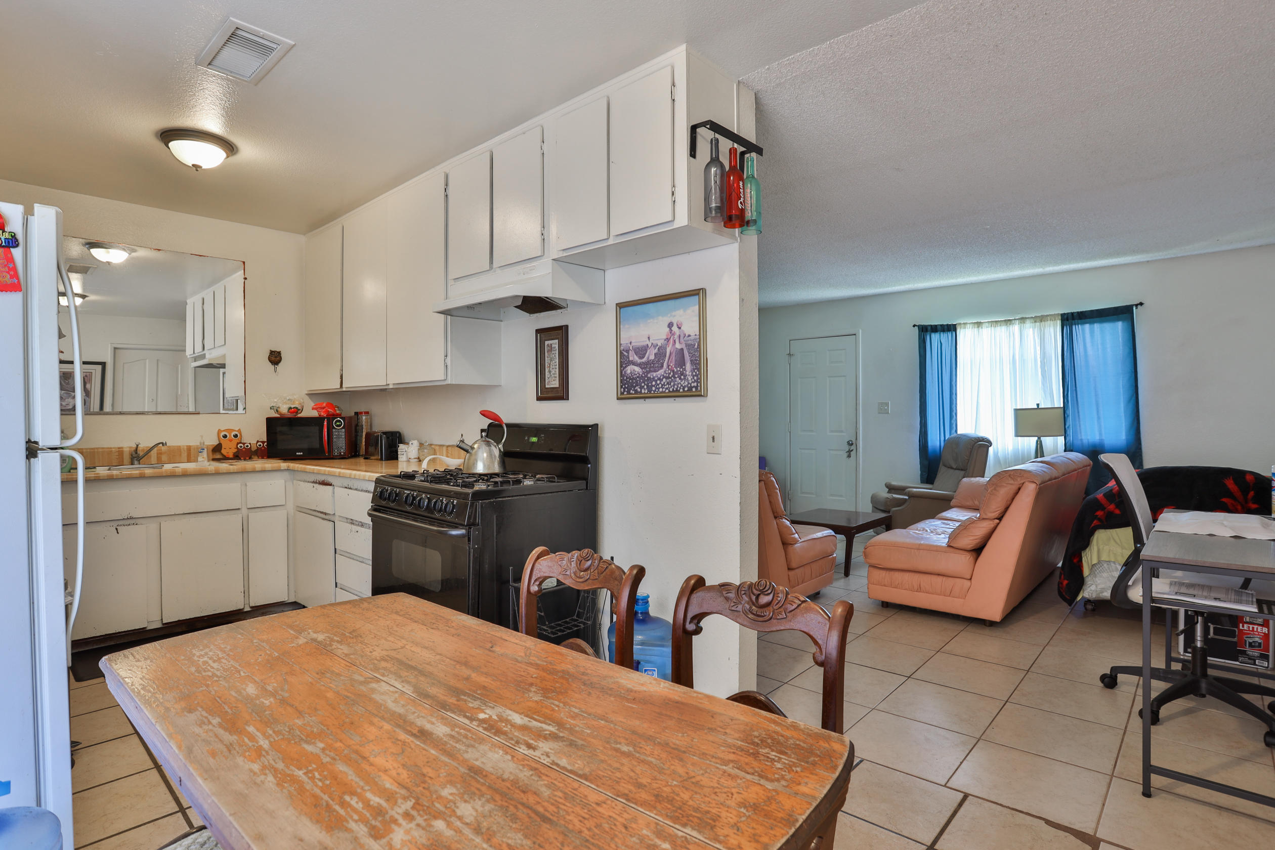 464 Riverside Avenue Rialto, CA 92376 - Photo 9 of 33 a kitchen with stainless steel appliances granite countertop a stove a sink dishwasher and a refrigerator with wooden cabinets