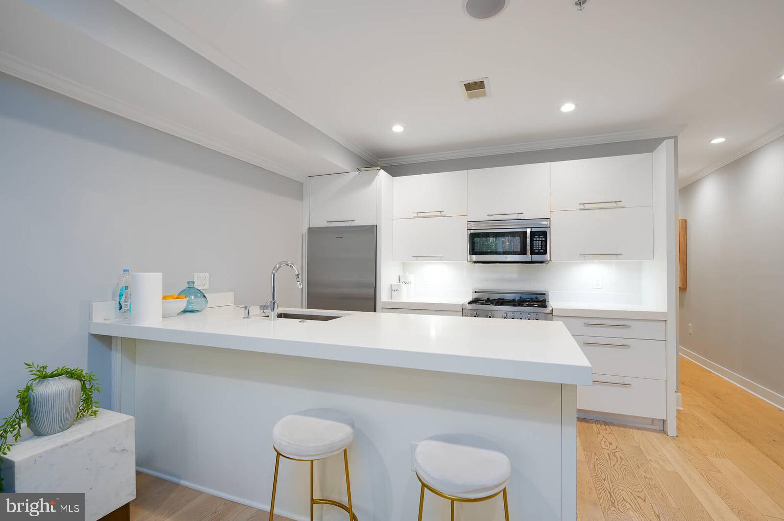 1461 Chapin Street Northwest Washington, DC 20009 - Photo 58 of 67 Sleek modern kitchen with bright finishes.