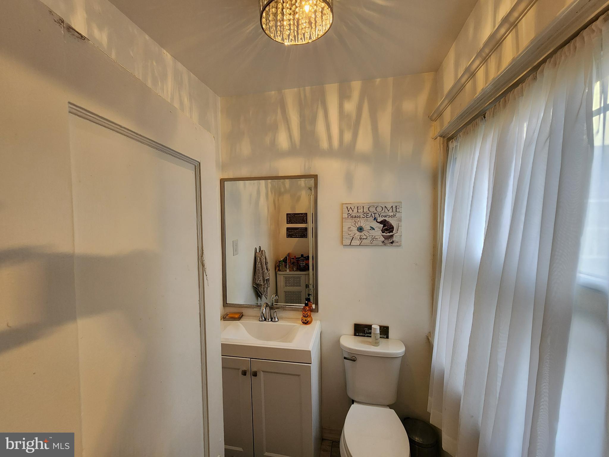 1729 68th Avenue Philadelphia, PA 19126 - Photo 18 of 38 a bathroom with a toilet a sink and mirror