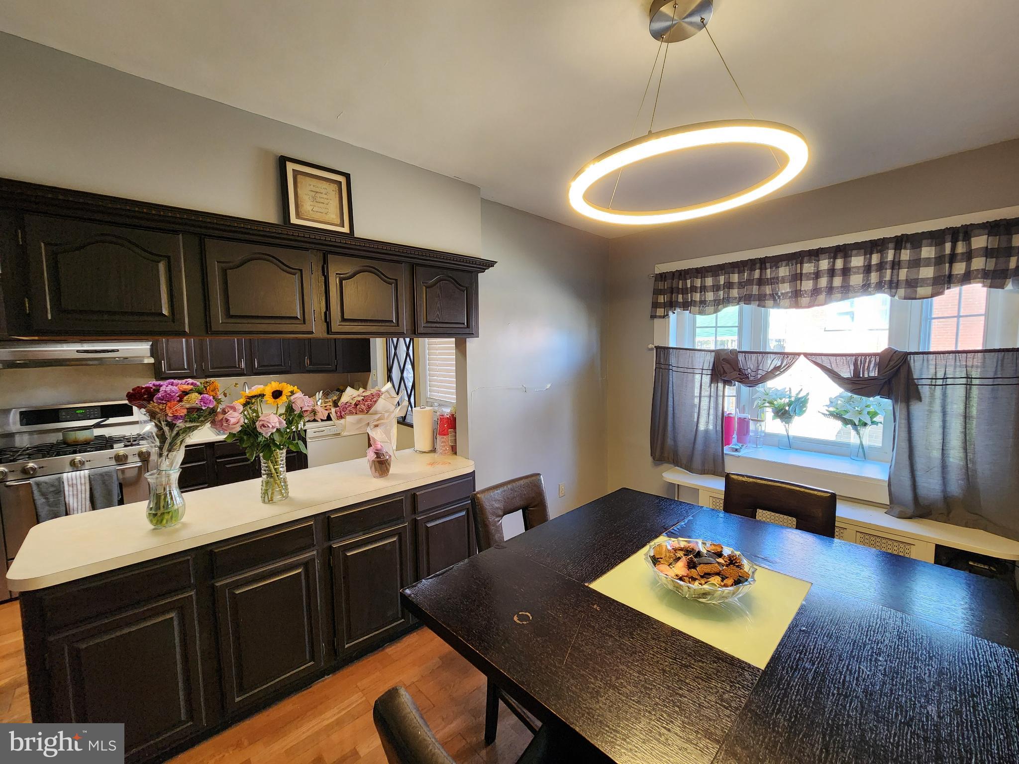 1729 68th Avenue Philadelphia, PA 19126 - Photo 20 of 38 a kitchen with stainless steel appliances granite countertop a sink dishwasher stove and cabinets with wooden floor
