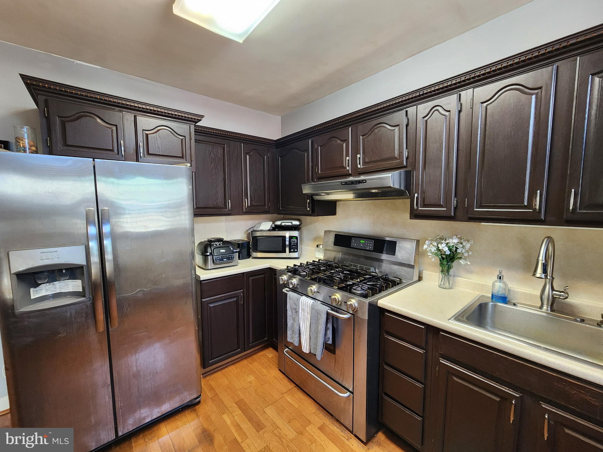 1729 68th Avenue Philadelphia, PA 19126 - Photo 23 of 38 a kitchen with stainless steel appliances granite countertop a stove a sink dishwasher and a refrigerator