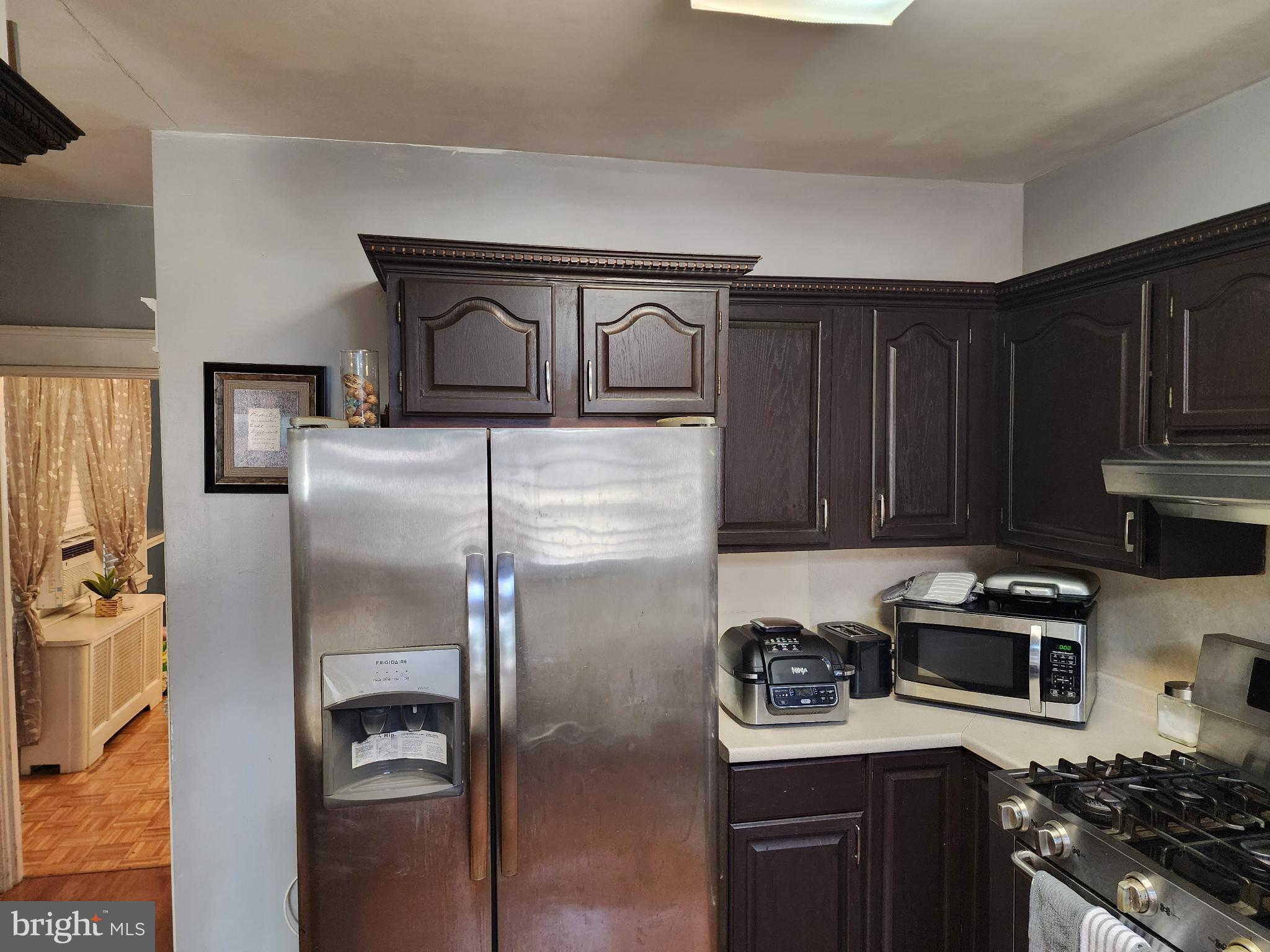 1729 68th Avenue Philadelphia, PA 19126 - Photo 24 of 38 a kitchen with kitchen island granite countertop stainless steel appliances and a refrigerator