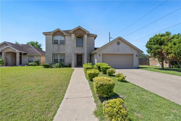 a front view of house with yard and green space
