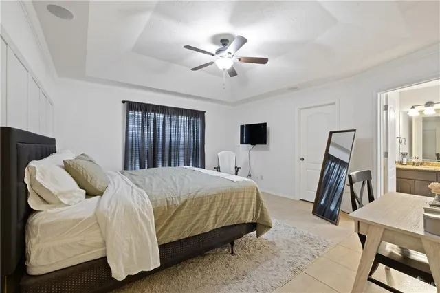 a bed room with a bed and a ceiling fan