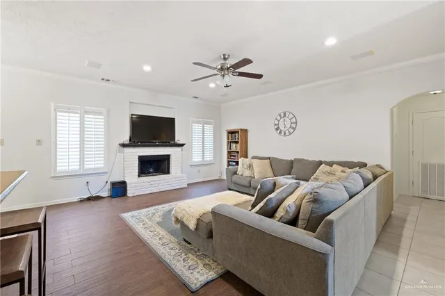 a living room with furniture flat screen tv and a fireplace