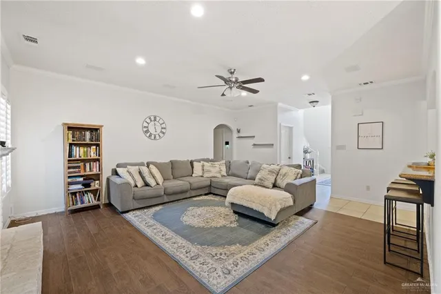 a living room with furniture a rug and a chandelier
