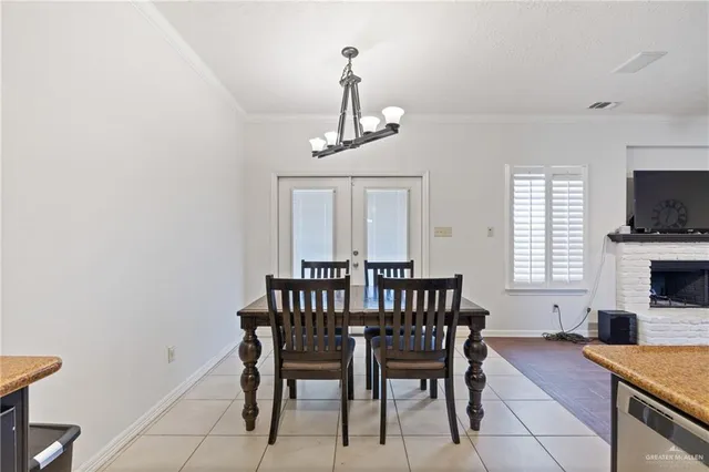 a view of a dining room with furniture and a chandelier