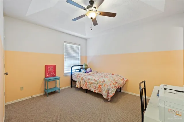 a bedroom with a bed chandelier and a window