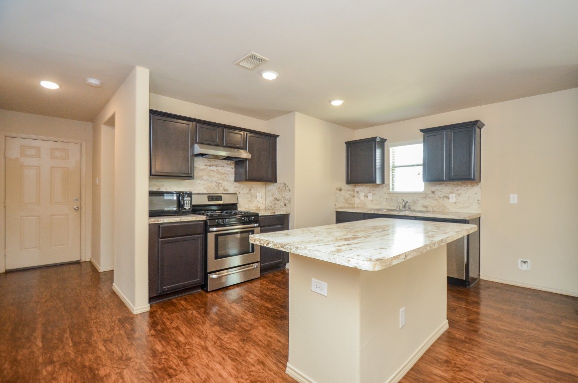 20114 Louetta Ash Drive Spring, TX 77388 - Photo 11 of 32 a kitchen with a sink stove and refrigerator