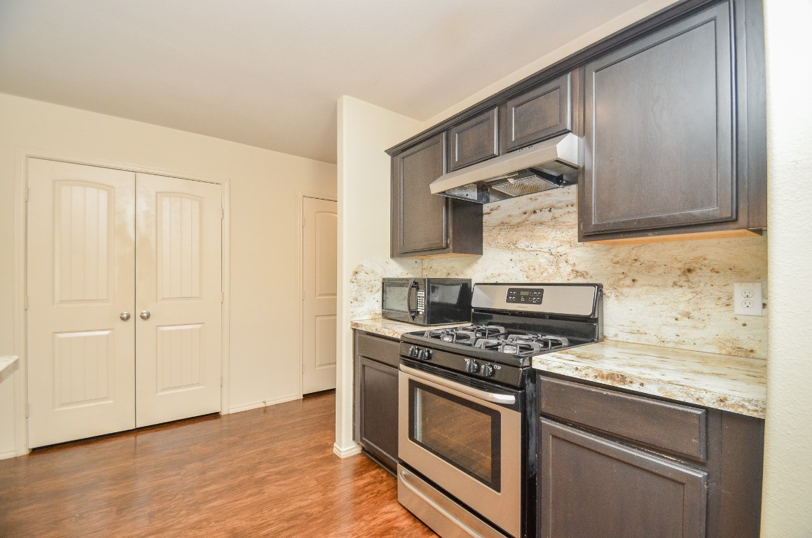 20114 Louetta Ash Drive Spring, TX 77388 - Photo 13 of 32 a kitchen with granite countertop a stove and a sink
