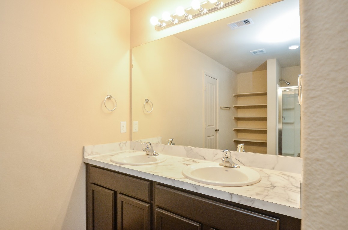 20114 Louetta Ash Drive Spring, TX 77388 - Photo 18 of 32 a bathroom with a sink and a mirror