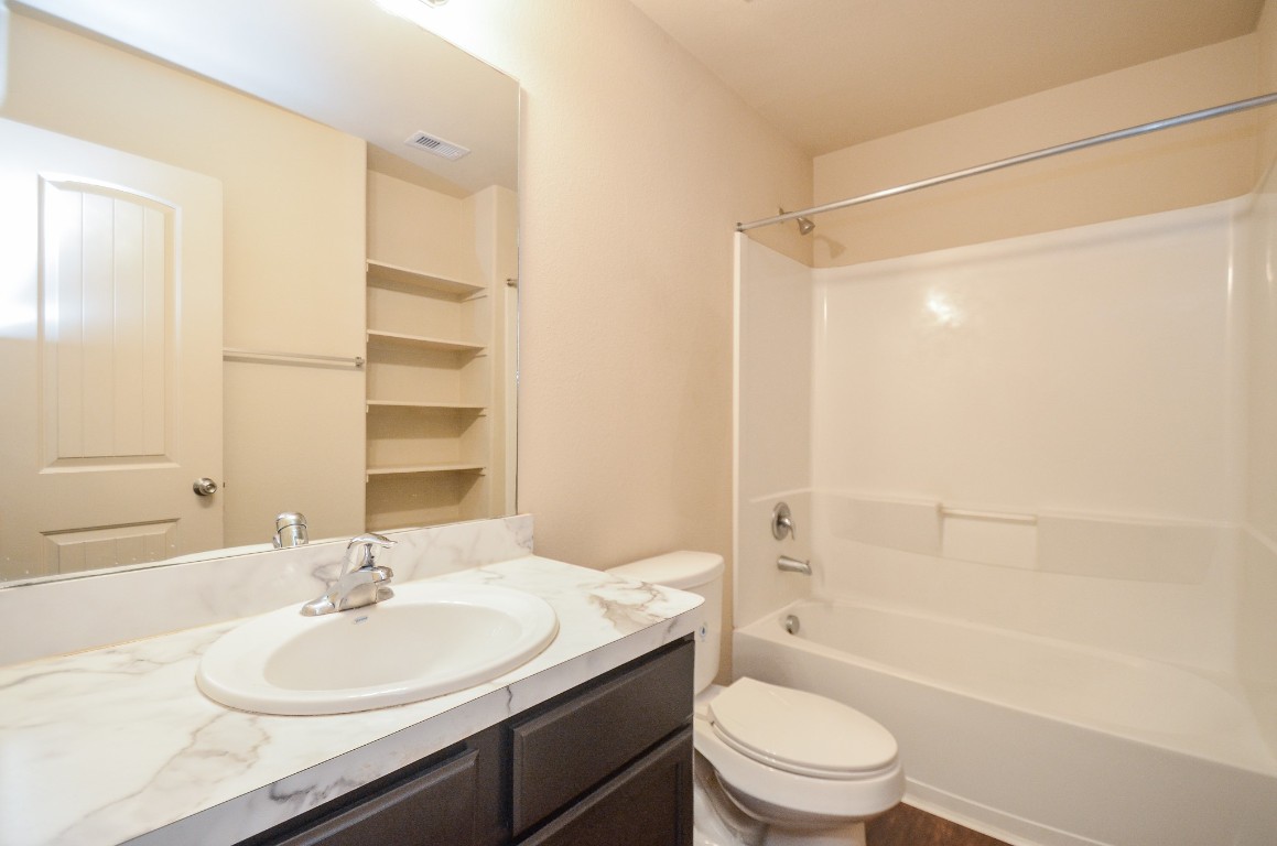 20114 Louetta Ash Drive Spring, TX 77388 - Photo 27 of 32 a bathroom with a sink a toilet and shower