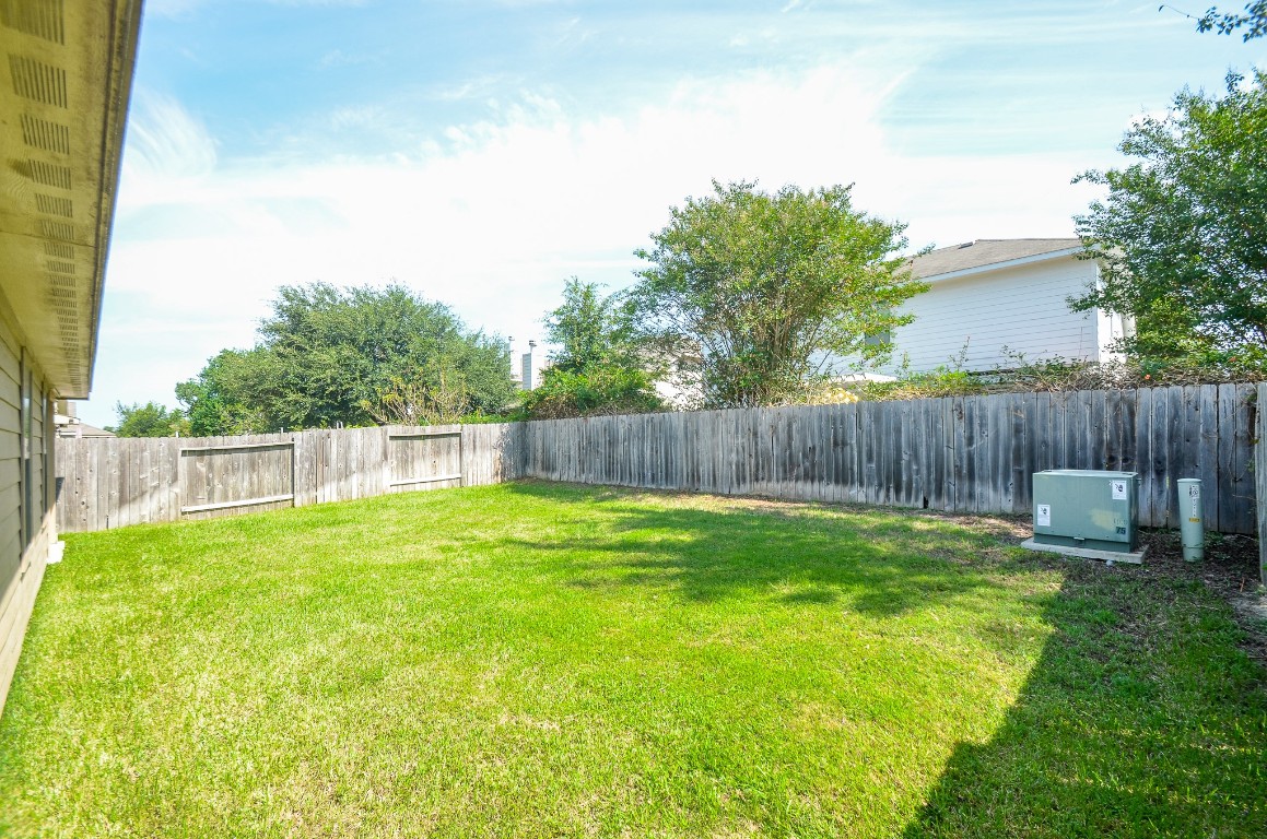 20114 Louetta Ash Drive Spring, TX 77388 - Photo 3 of 32 a backyard with table and chairs and wooden fence