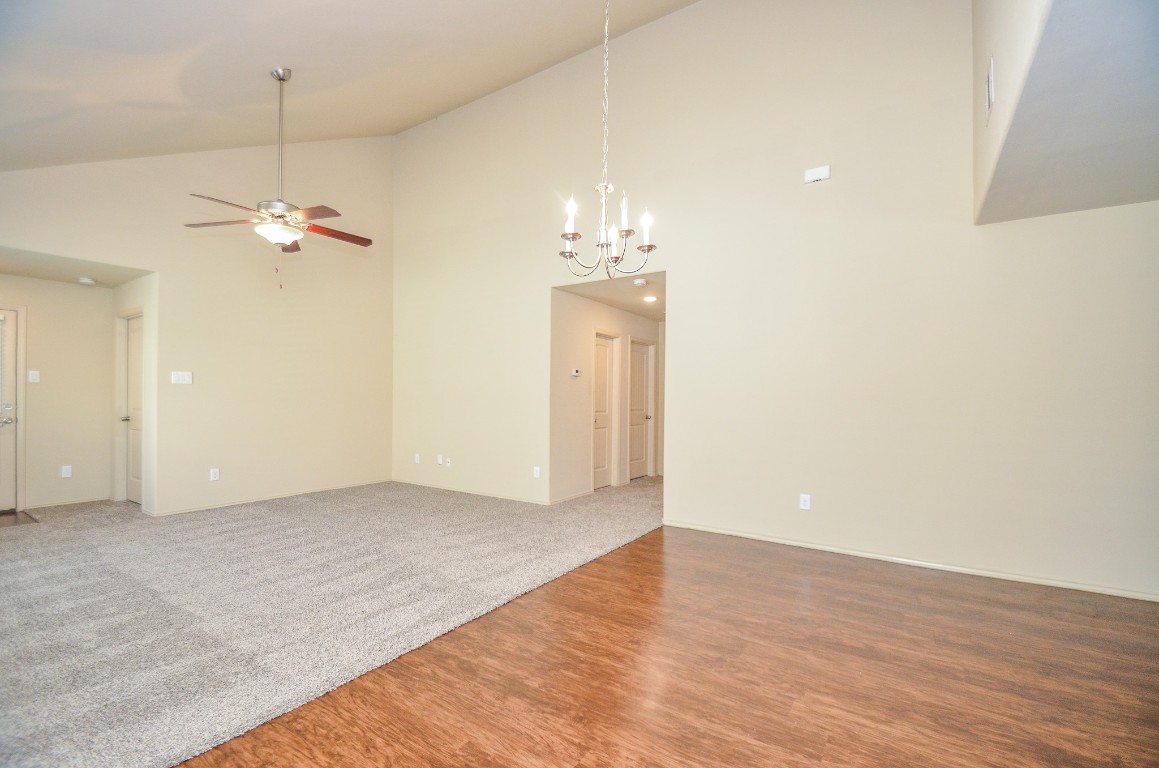 20114 Louetta Ash Drive Spring, TX 77388 - Photo 10 of 32 an empty room with a chandelier fan and wooden floor