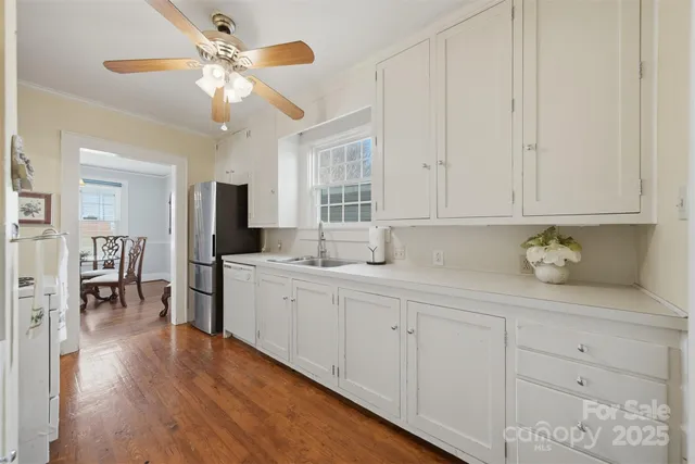 a kitchen with sink cabinets and wooden floor