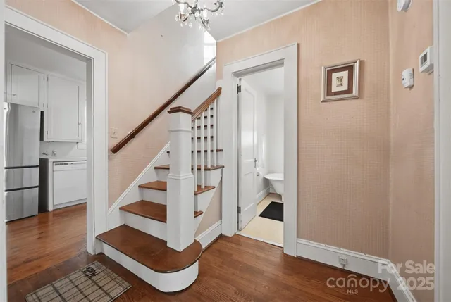 a view of entryway and hall with wooden floor