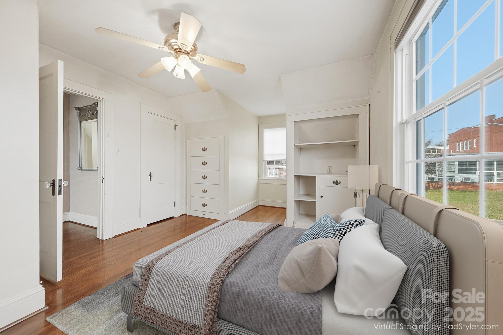 323 4th St Place Southwest Hickory, NC 28602 - Photo 20 of 32 a bedroom with a bed and a chandelier