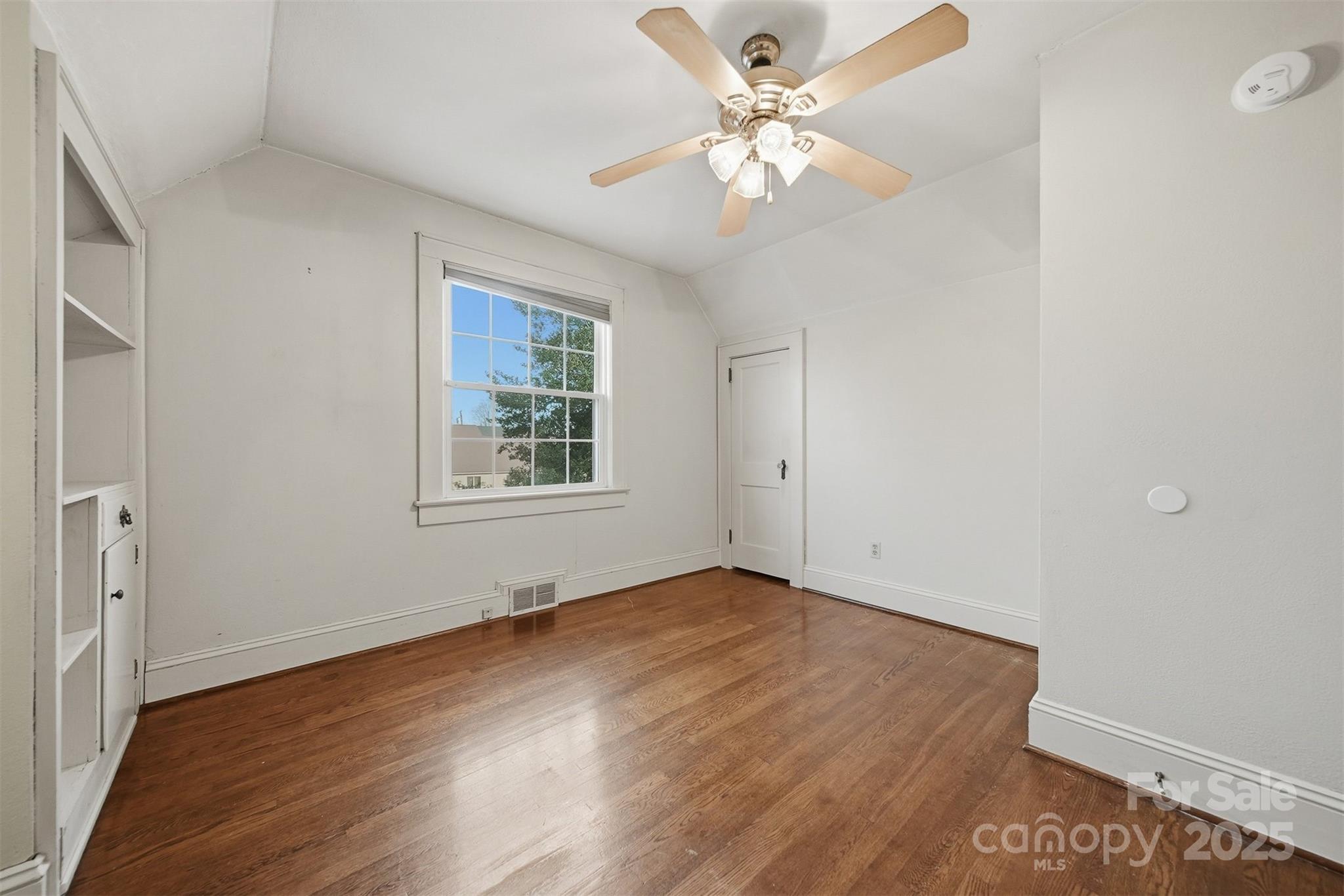 323 4th St Place Southwest Hickory, NC 28602 - Photo 21 of 32 an empty room with wooden floor chandelier fan and windows