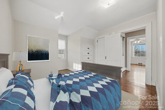 a bedroom with a bed and wooden floor