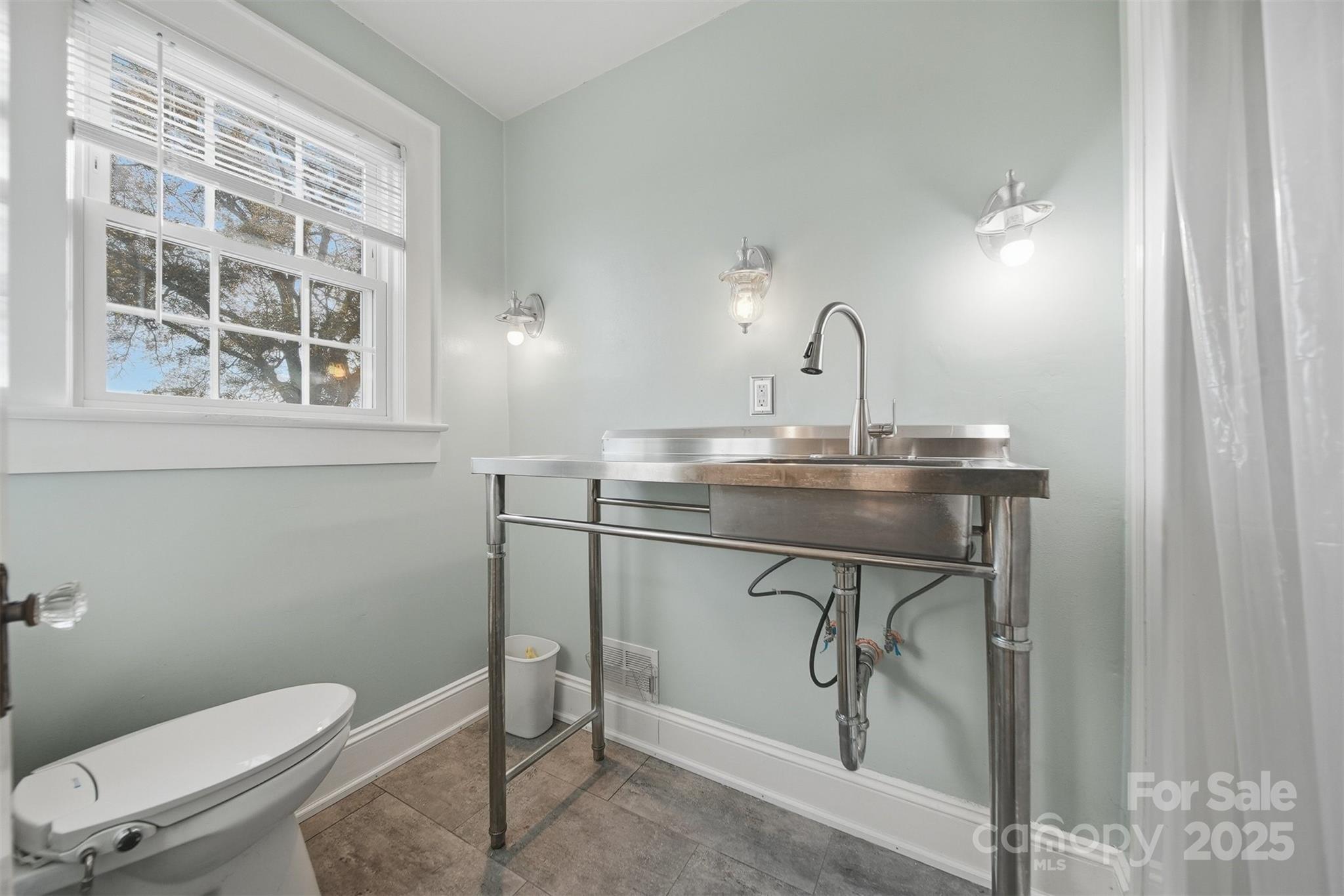 323 4th St Place Southwest Hickory, NC 28602 - Photo 24 of 32 a bathroom with a toilet a sink and a window