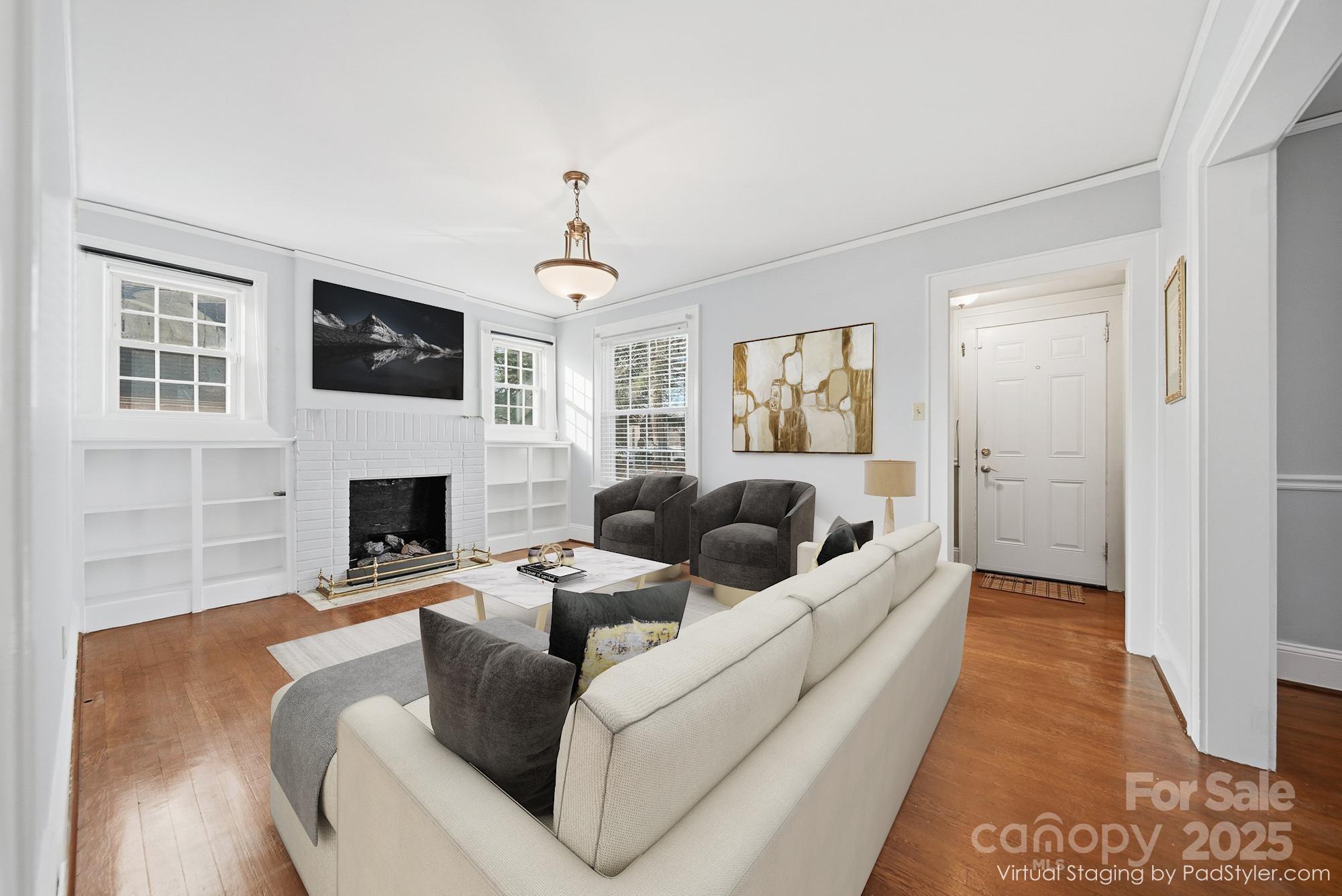 323 4th St Place Southwest Hickory, NC 28602 - Photo 3 of 32 a living room with furniture a flat screen tv and a fireplace