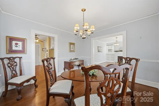 a view of a dining room with furniture and chandelier