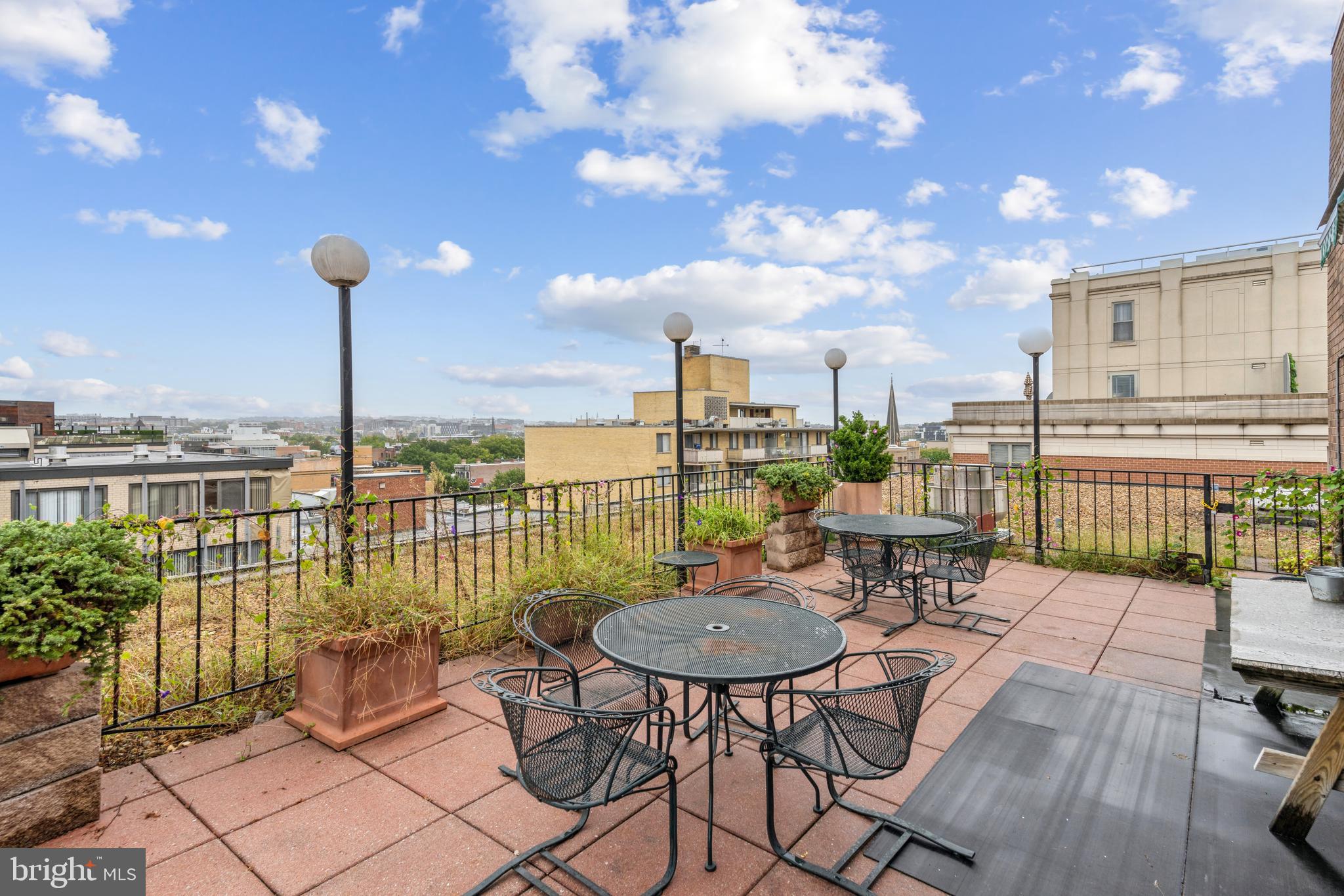 1420 N Street Northwest, Unit 402 Washington, DC 20005 - Photo 3 of 20 a view of a patio with a table and chairs