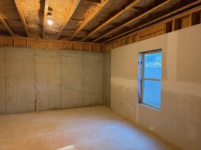 a view of an empty room with wooden walls