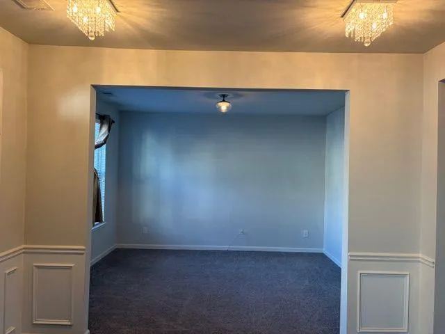 a kitchen with stainless steel appliances granite countertop a refrigerator a stove and a wooden floors