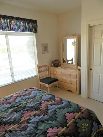 a bedroom with bed and a window