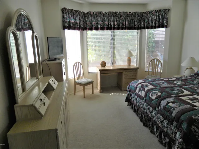 a kitchen with a stove a window and a flat screen tv