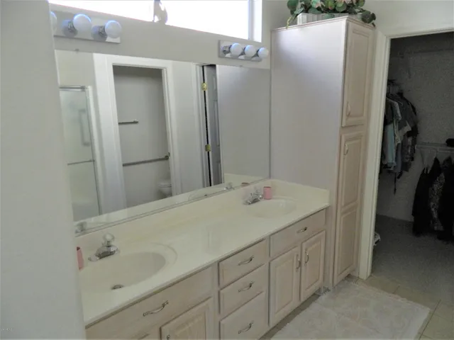 a bathroom with a double vanity sink and mirror