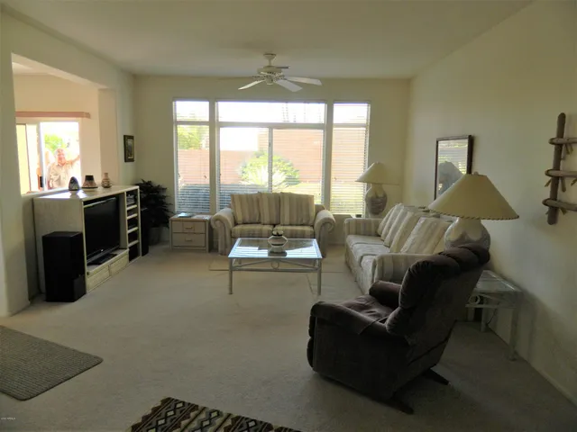 a living room with furniture and a large window