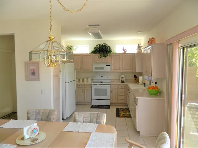 a view of a dining room with a table and chairs