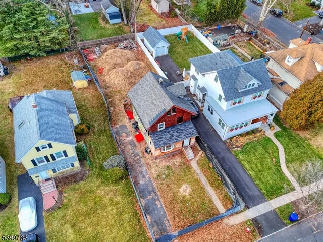 an aerial view of a house with a garden and lake view