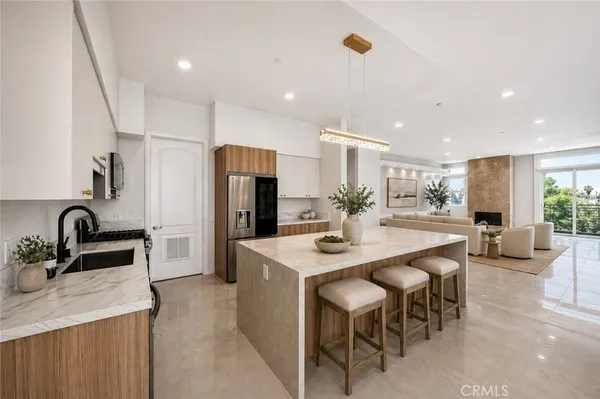 a kitchen with refrigerator and sink