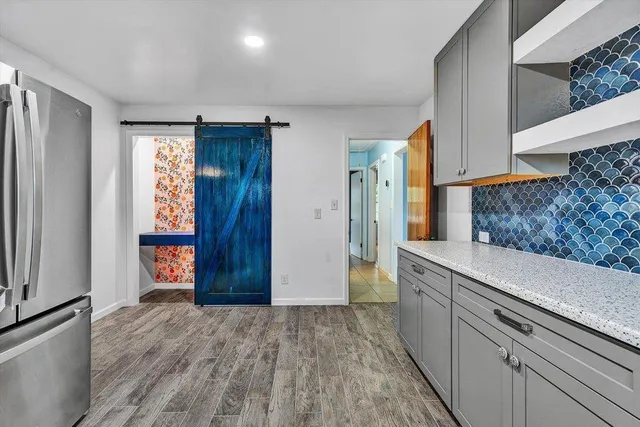 a view of an entryway with wooden floor