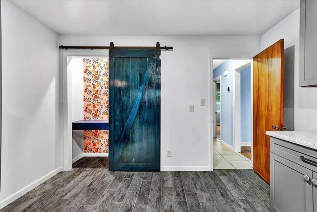 an entryway with wooden floor and a window