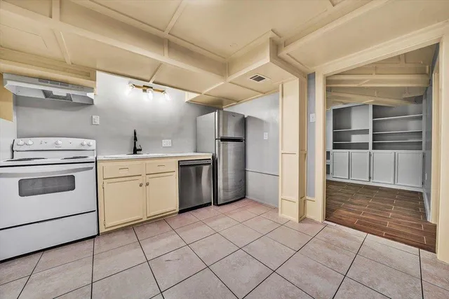a kitchen with a stove top oven cabinets and stainless steel appliances