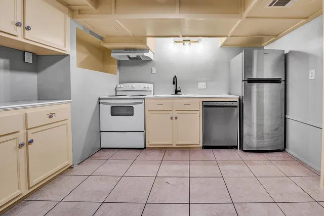 a kitchen with a stove top oven and cabinets