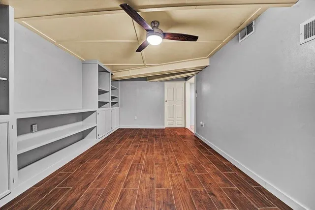 a view of a room with wooden floors and led lights