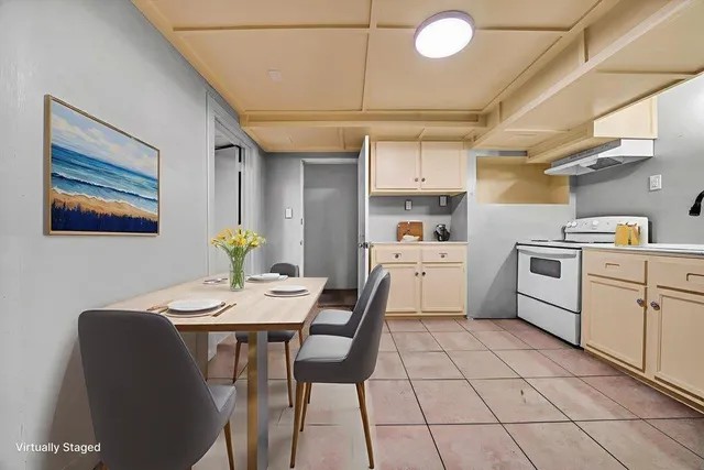 a living room with furniture a flat screen tv and kitchen view