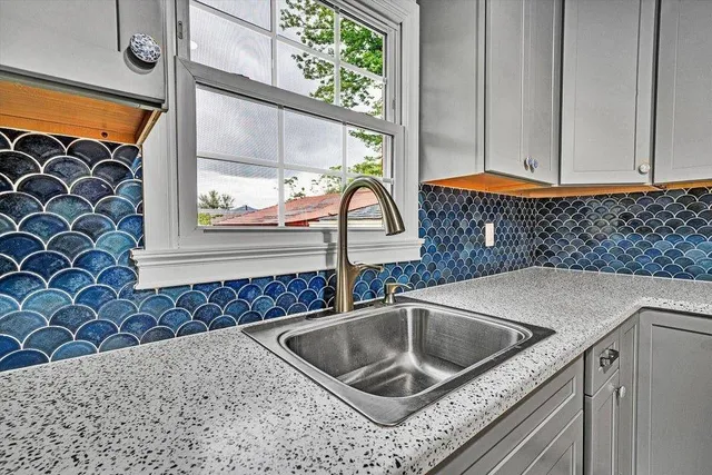 a kitchen with a sink and a stove top oven