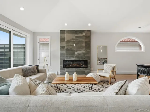 a living room with furniture and a fireplace