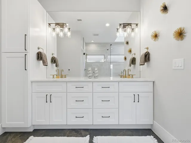 a bathroom with a sink vanity and mirror