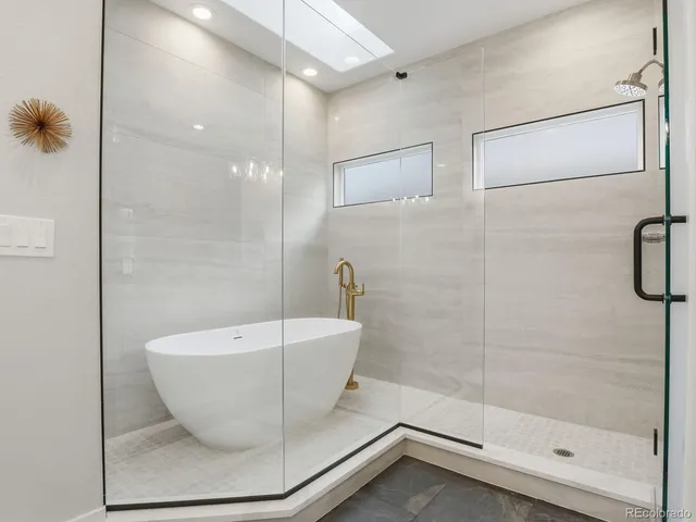 a bathroom with a bathtub and shower