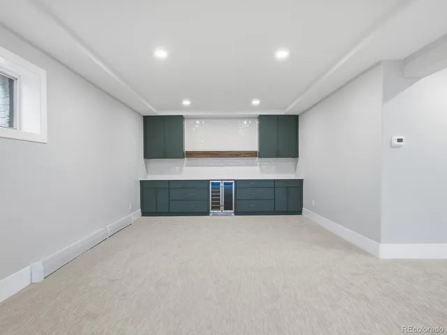 a view of an empty room with a kitchen