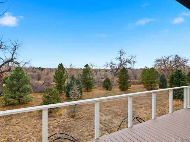 a view of a balcony with wooden fence