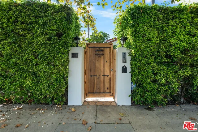 a view of a wooden door and a yard